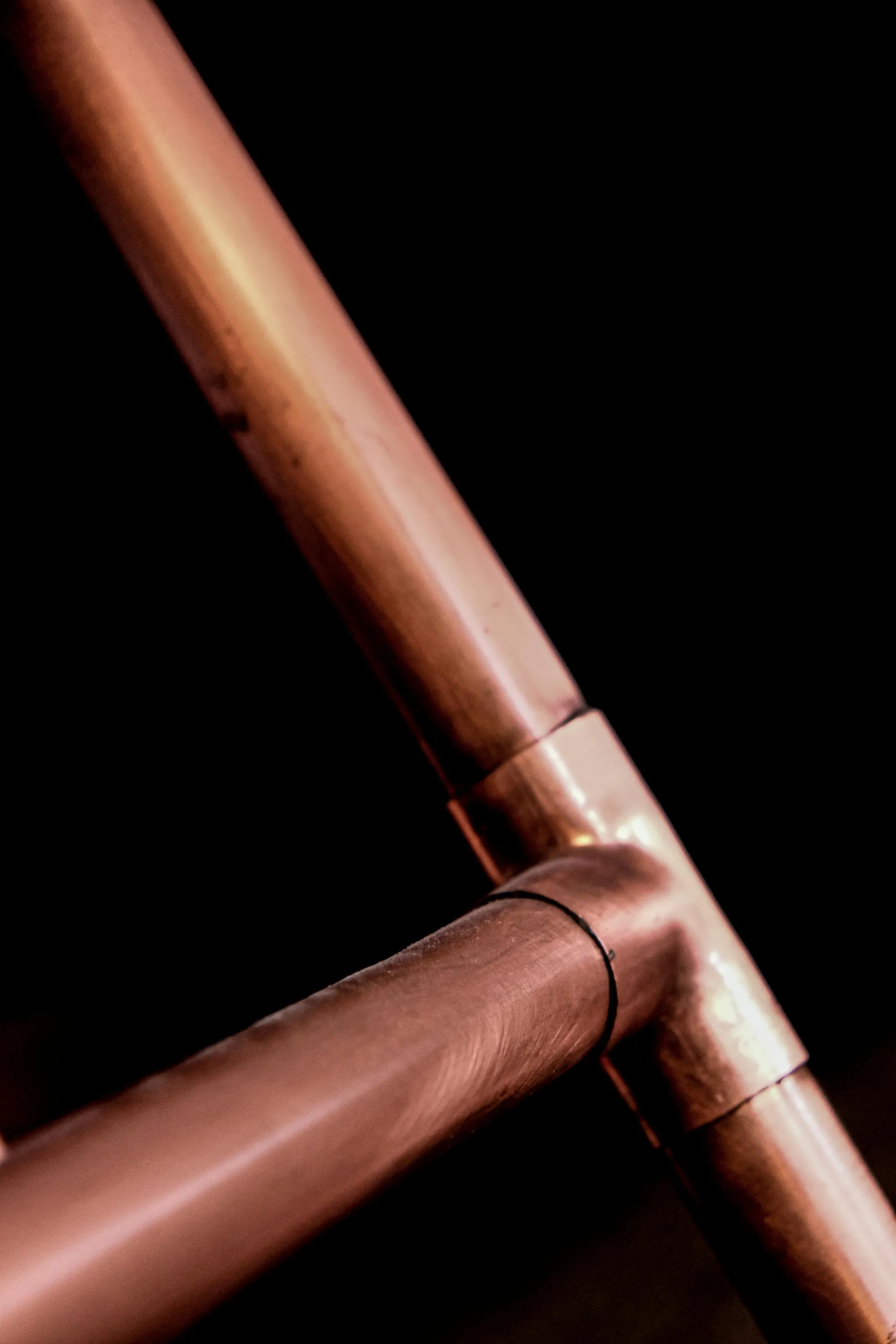 Soldered copper pipework on a kitchen wall